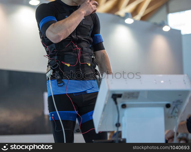 Boy Wearing Black Jacket with Electrode: Muscular Electrostimulation.. Boy Wearing Black Jacket with Electrode: Muscular Electrostimulation