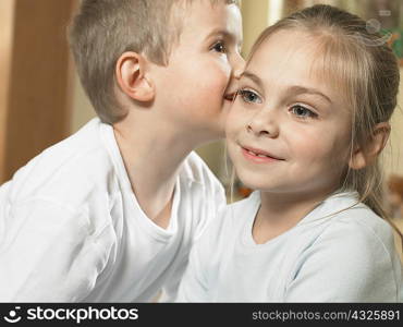 Boy whispering in girls ear