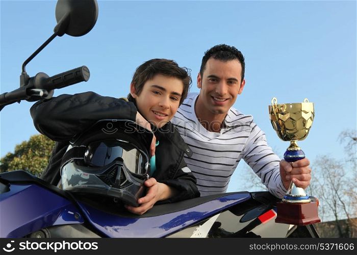 boy winning a motorcycle racing cup
