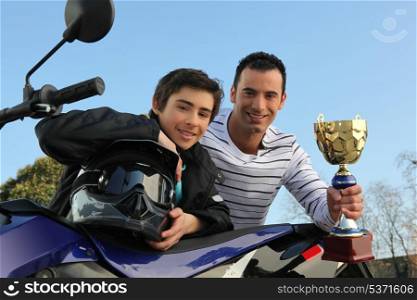 boy winning a motorcycle racing cup