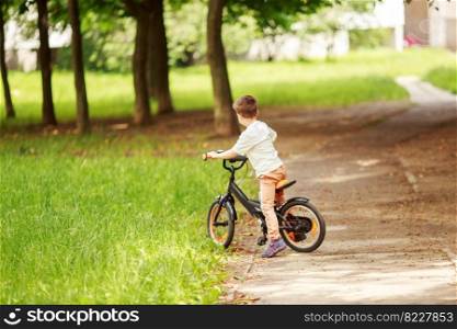 Boy with a bicycle on the street.. Boy with a bicycle on the street