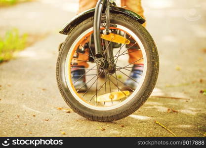 Boy with a bicycle on the street. wheel of a children&rsquo;s bicycle