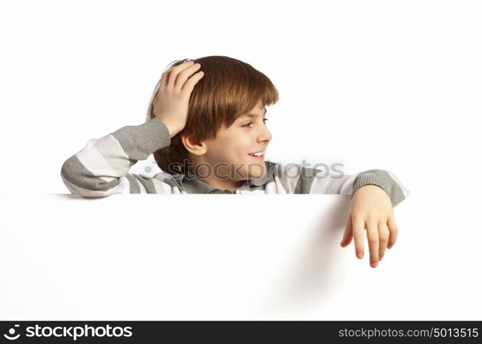 Boy with a blank billboard. Little boy holding a blank white billboard