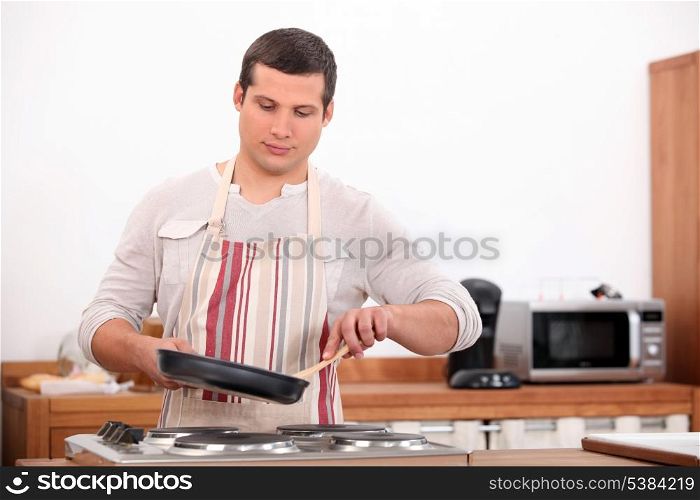 Boy with a pan in the kitchen