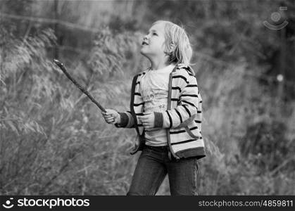 Boy with a stick playing outdoors