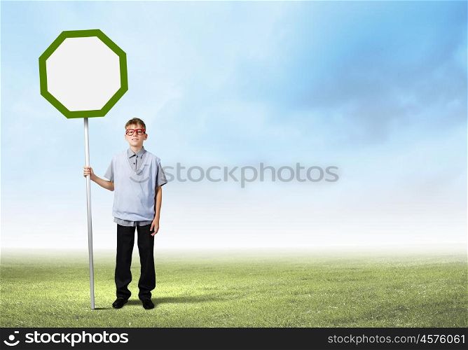 Boy with banner. Boy of school age in glasses holding blank road sign