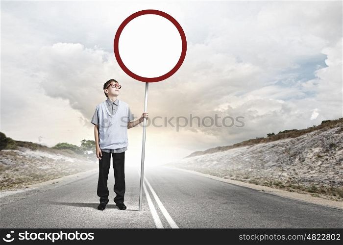 Boy with banner. Boy of school age in glasses holding blank road sign