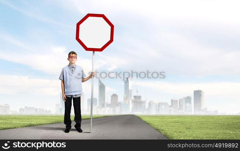 Boy with banner. Boy of school age in glasses holding blank road sign