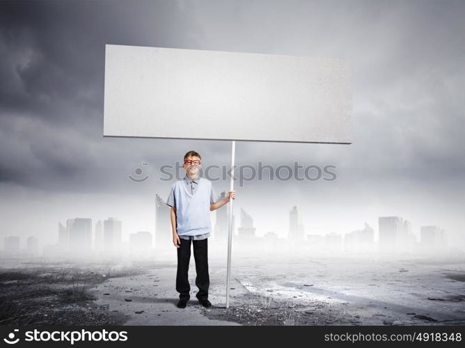 Boy with banner. Boy of school age in glasses holding blank white banner