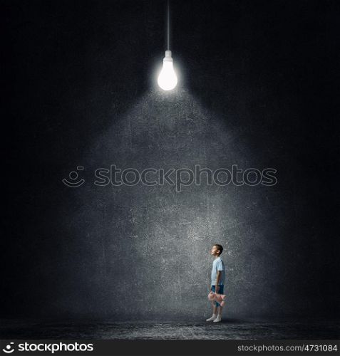 Boy with bear toy. Cute little boy with toy bear in concrete dark room