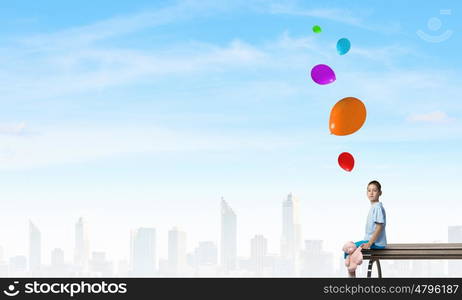 Boy with bear toy. Cute little boy with toy bear sitting on wooden bench