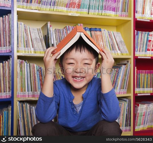 Boy with Book on His Head