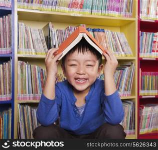Boy with Book on His Head