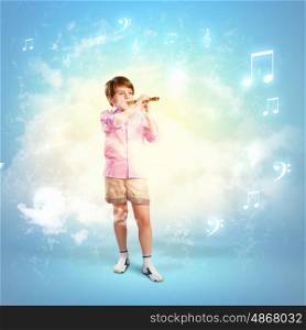 Boy with flute. Image of little cute boy playing on flute against cloudy background