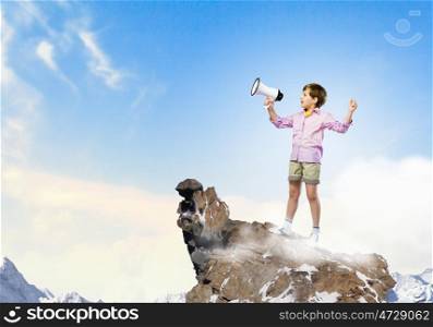Boy with flute. Image of little cute boy shouting in megaphone