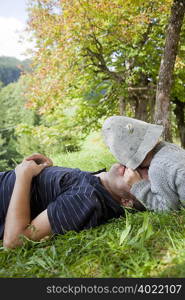 Boy with hat cuddling his father