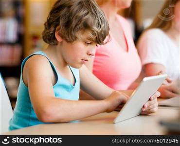 Boy with his famile on background in library with computer. Boy in library with computer