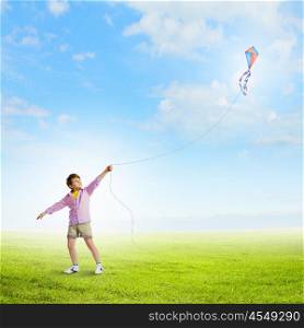 Boy with kite. Little boy playing with kite on meadow. Childhood concept