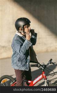 boy with safety helmet riding his bike