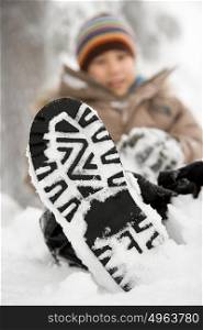 Boy with snow on his shoe