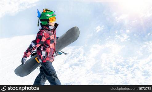 Boy with Snowboard in the Mountain Winter Resort