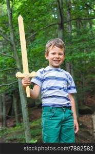 Boy with sword on a walk in the park.