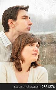 boy with the girl against background of wet window