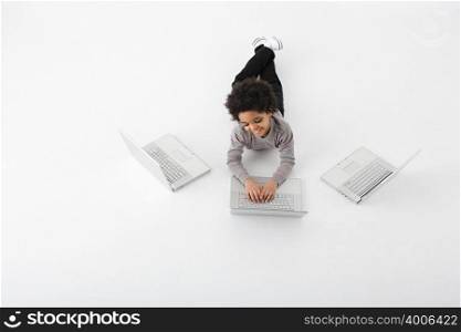 Boy with three laptops