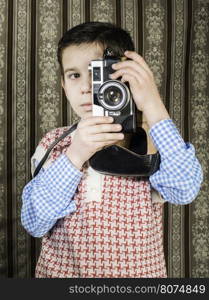 Boy with vintage camera. Vintage clothes