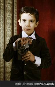 Boy with vintage camera. Vintage clothes