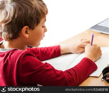 boy writing indoors
