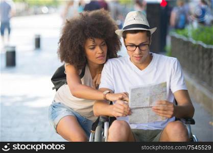 boyfriend in wheelchair checking the map