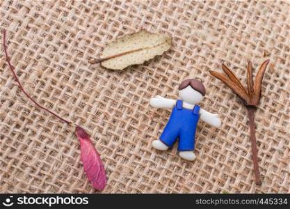 Boys figurine and flowers and leaves on canvas