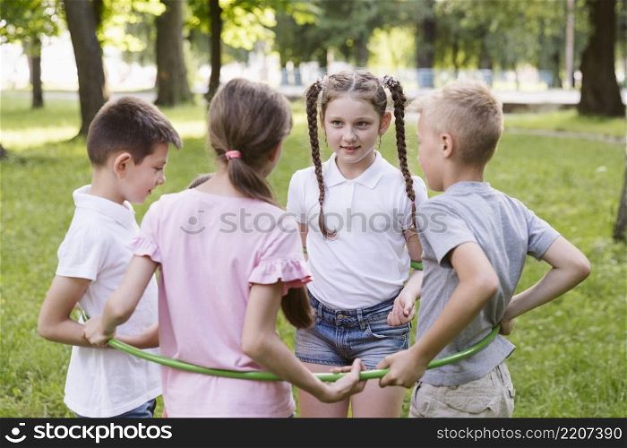 boys girls playing with hula hoop