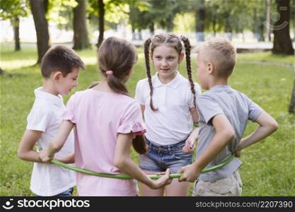 boys girls playing with hula hoop