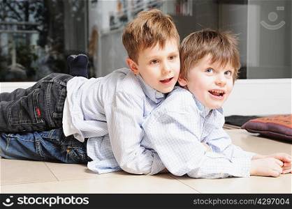 Boys hugging on living room floor