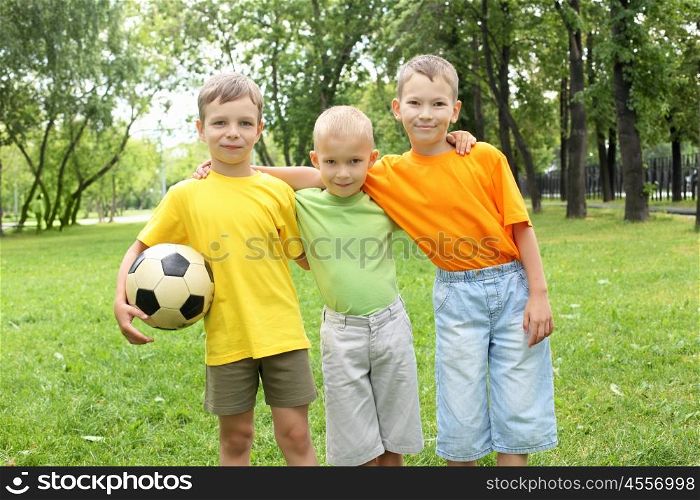 Boys in the summer park with a football ball