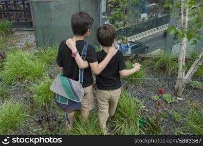 Boys looking at street from High Line Park, Chelsea, Manhattan, New York City, New York State, USA
