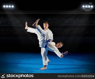 Boys martial arts fighters at sports hall