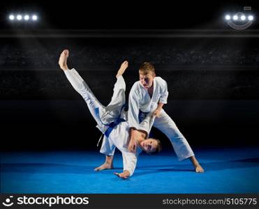 Boys martial arts fighters at sports hall