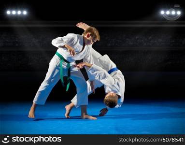 Boys martial arts fighters in sports hall