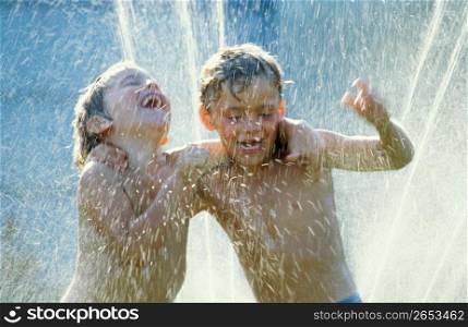 Boys playing in fountain