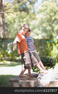 Boys playing in fountain