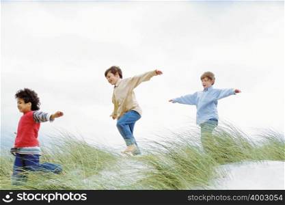 Boys playing on a dune