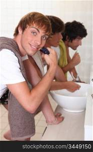 Boys shaving and brushing their teeth