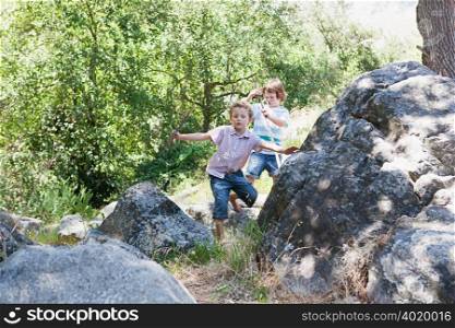 Boys walking through rocks