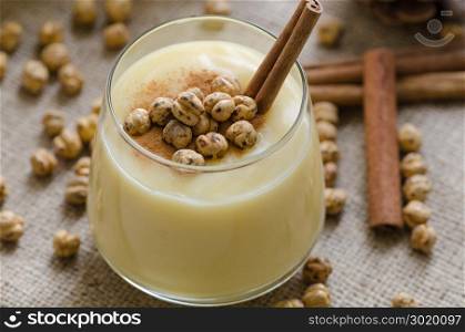 Boza or Bosa, traditional Turkish drink with roasted chickpeas and cinnamon on the table. top view
