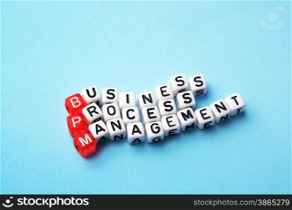 bpm business process management on dices on blue background