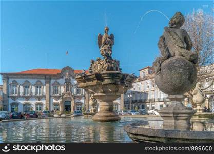 BRAGA, PORTUGAL - CIRCA FEBRUARY 2019: Fountain in Praca do Municipio or Town Hall Square in Braga downtown, North of Portugal. Braga urban cityscape, one of the oldest cities of Portugal. Sunny day with blue sky