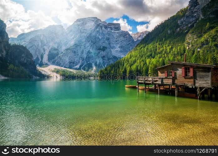 Braies Lake in Dolomites mountains Seekofel in background, Sudtirol, Italy. Lake Braies is also known as Lago di Braies. The lake is surrounded by the mountains which are reflected in the water.